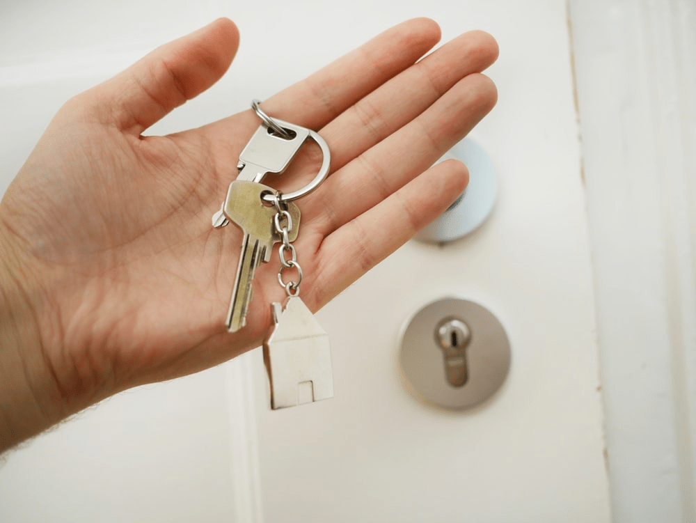 a person holding house keys.