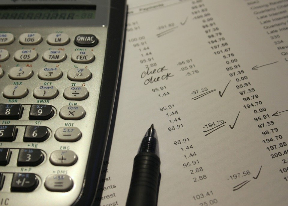 a pen and calculator on a financial statement